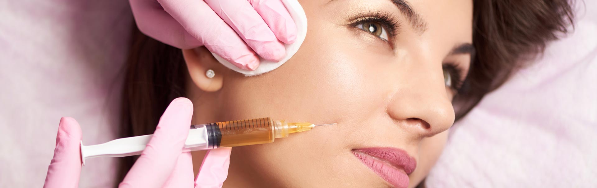 Woman getting dermal fillers injection